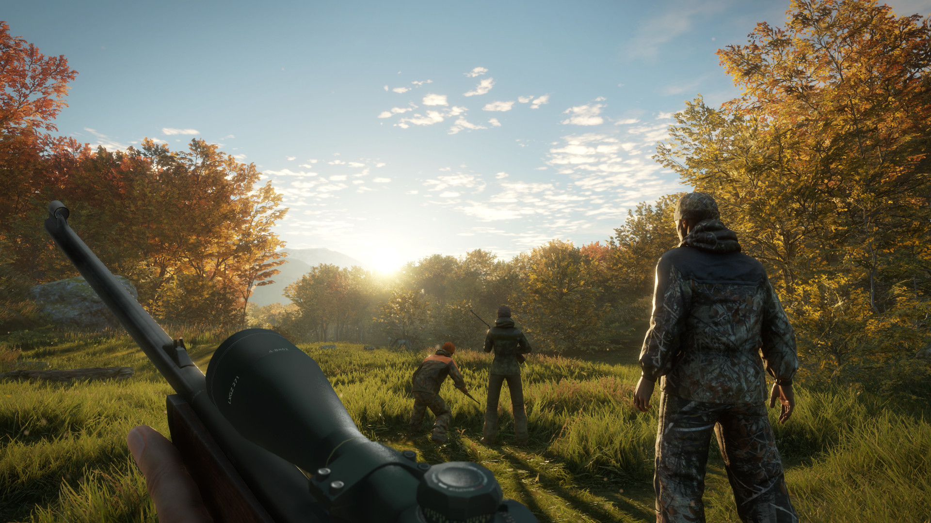 A group of hunters moving through an autumn reserve at sunrise